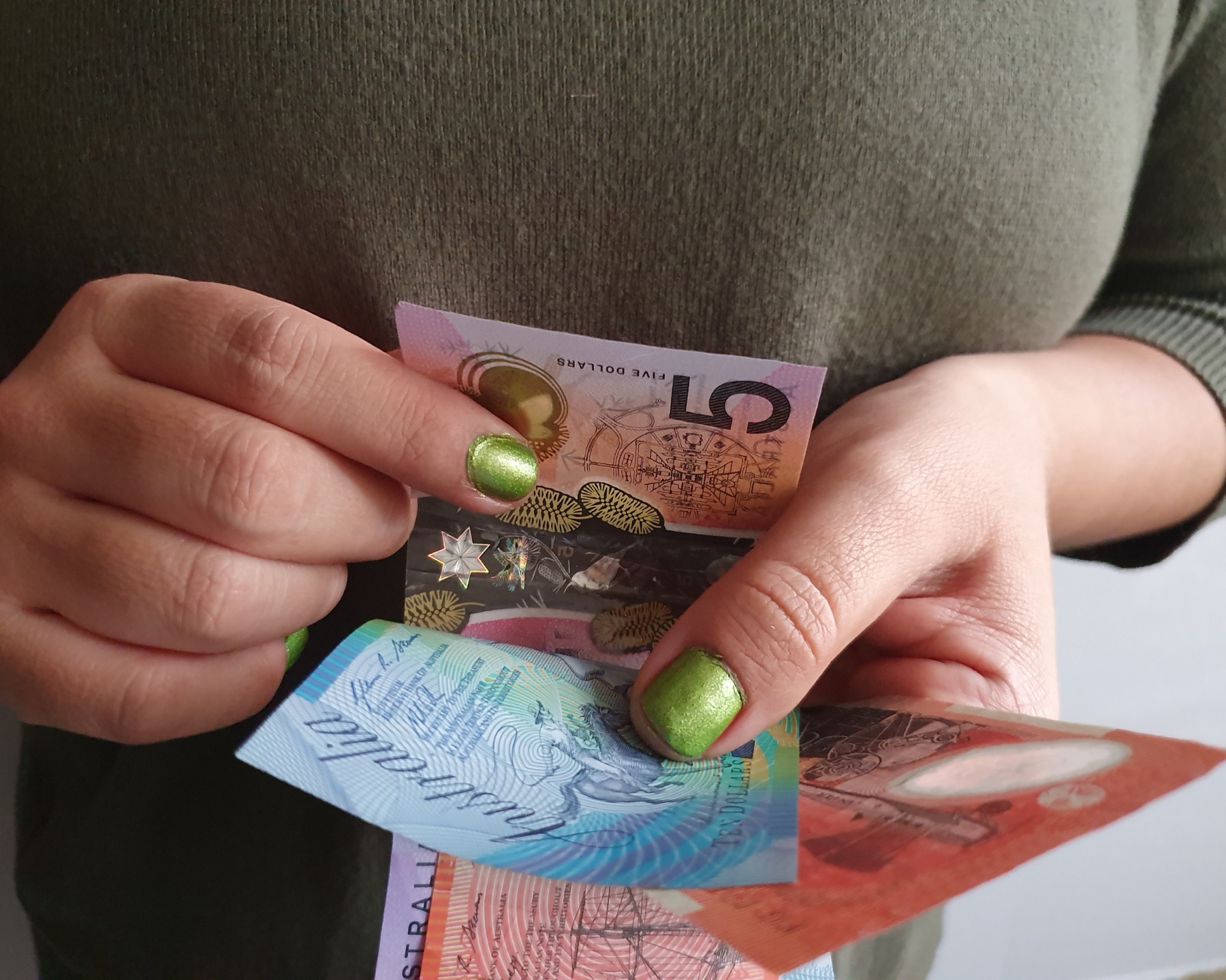 A customer counting Australian banknotes.