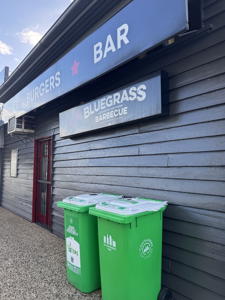 Green Containers for Change bins outside a hospitality venue.